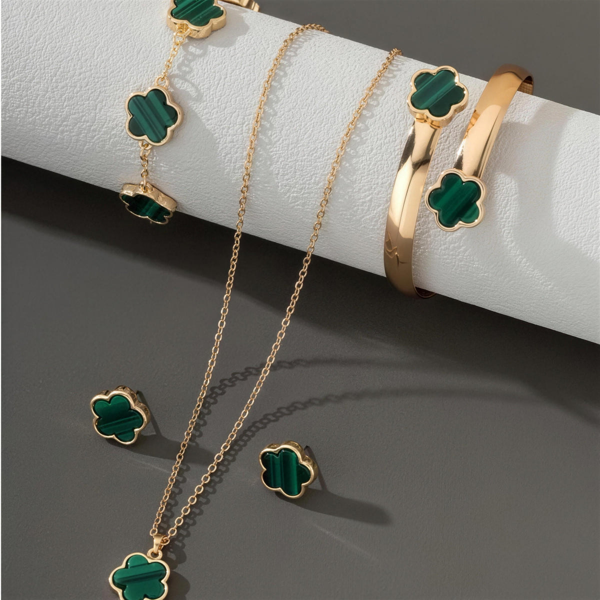 Green clover necklace, bracelet, bangle and earrings detail in gold