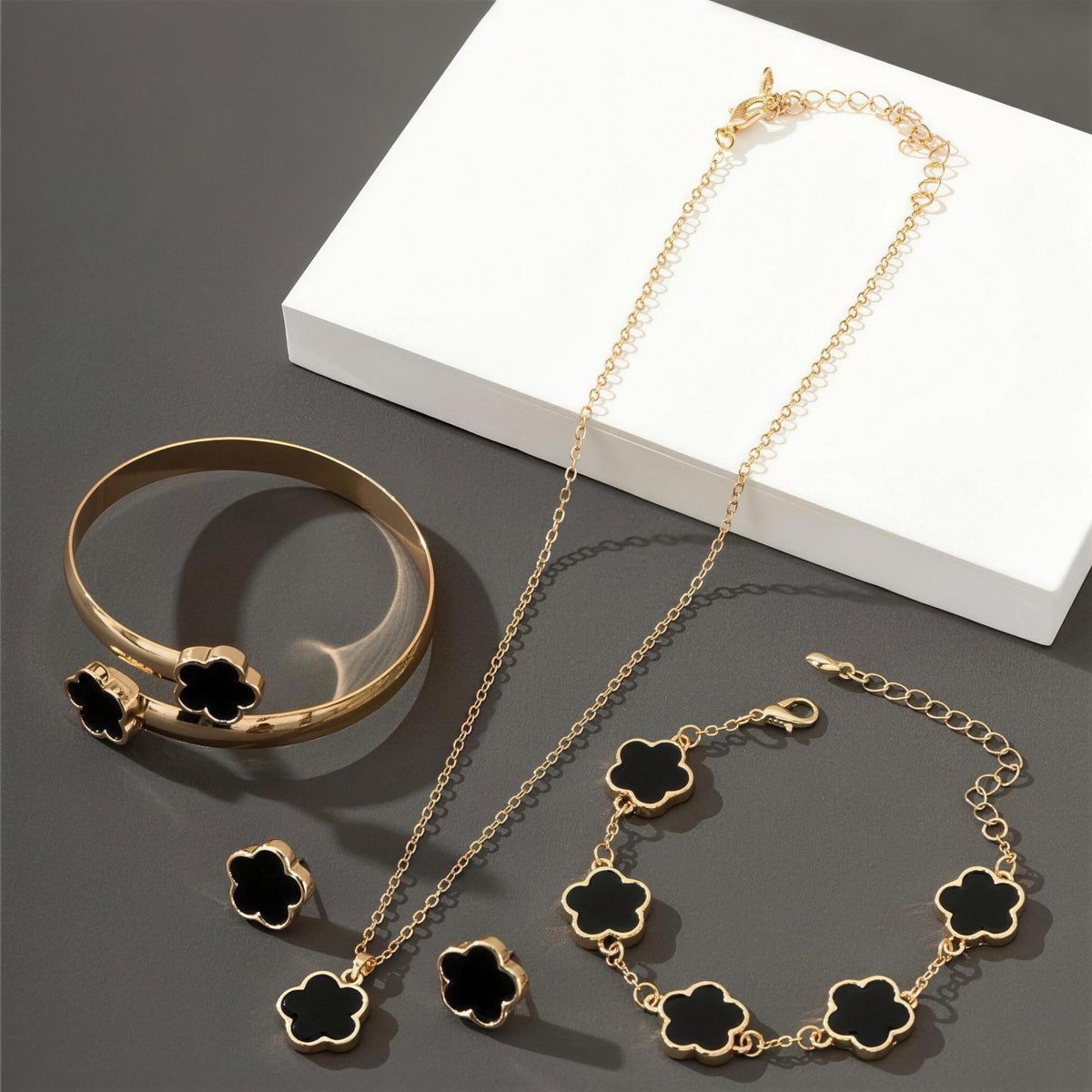 Lucky Clover Jewels 4-Piece Set in Black, gold clover necklace, bracelet, bangle and stud earrings